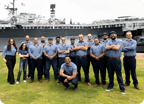 Plumbing Plus team members in front of a company service van.